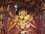 Tibet Guge 08 Tsaparang 03 Yamantaka Temple Guhysamaja-Manjuvajra On the left wall in yab-yum with his consort Sparshavajra are three paintings of the three-faced six-armed Guhyasamaja, Guhyasamaja-Manjuvajra and Guhyasamaja-Akshobyavajra, associated with the Buddha Akshobhya, and the most ancient and fundamental Tantra of Vajrayana tradition of Buddhism. Here is Guhyasamaja-Manjuvajra with his two central hands crossed near the centre of his body, his right hands holding a sword and arrow, and his left holding a lotus and bow. Sparshavajra�s two main hands circle Guhyasamaja- Manjuvajra, while her other hands mirror his. Photo: Weyer/Aschoff: Tsaparang, Tibets Grosses Geheimnis
